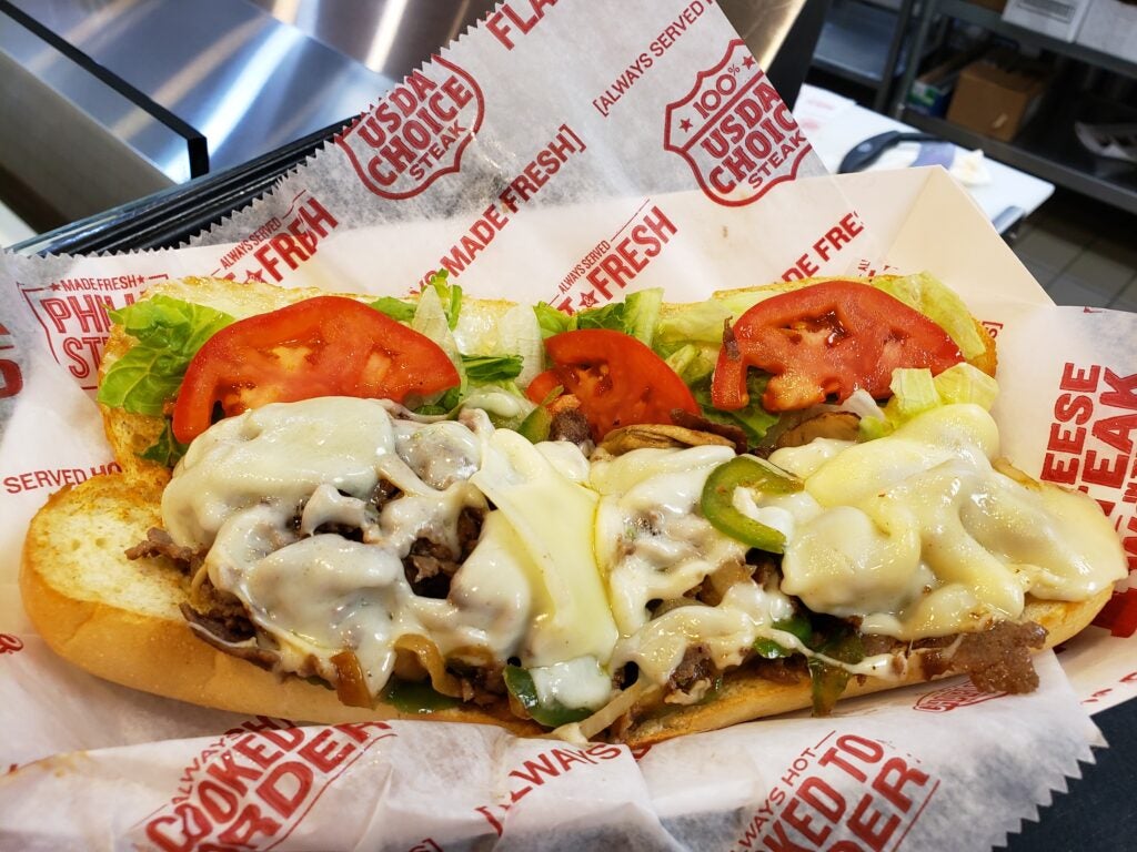 Philly Cheesesteak: Original cheesesteak with melted cheese, onions, peppers. Learn about the origin of cheesesteaks and why is it called Philly Cheesesteak. Find cheesesteaks near me
